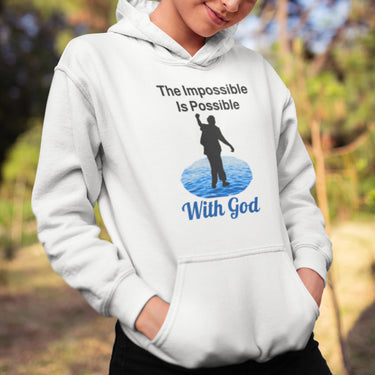 Gildan youth unisex hoodie with “Impossible Teen” design featuring a teen walking on water and uplifting message, Christian apparel made from soft preshrunk fleece, perfect for cold weather and spiritual encouragement, girl in white hoodie
